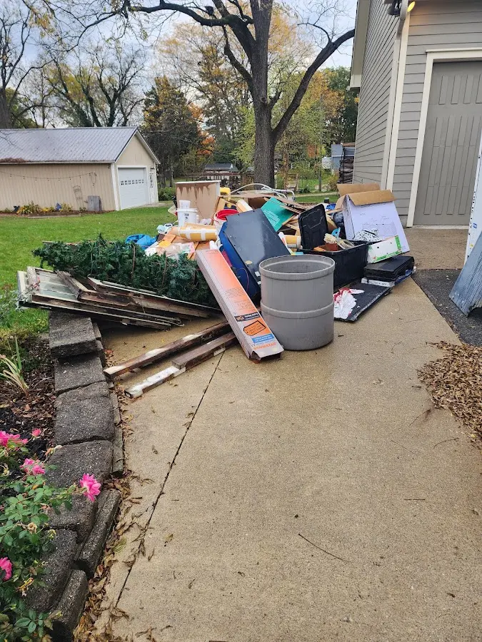 Dumpster being loaded with debris for Estate Cleanout Dumpster Rental in Reno